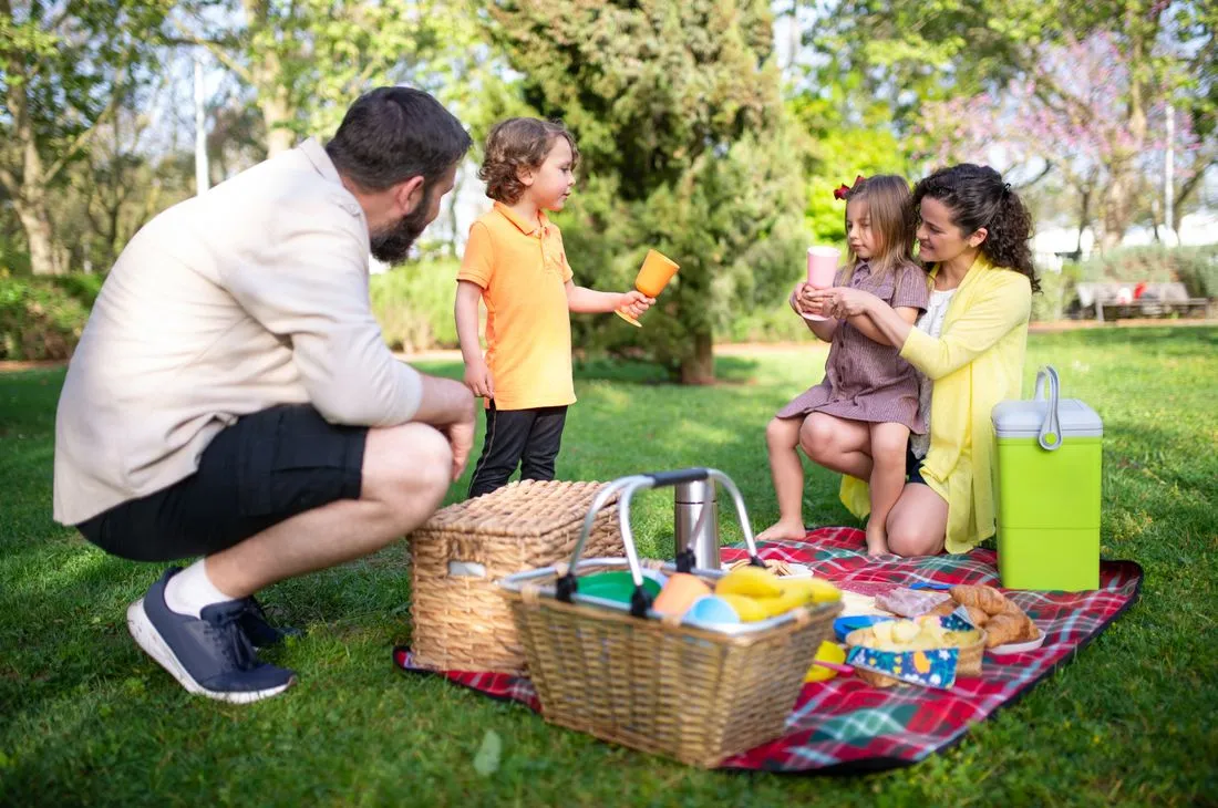 Three generations of a family walking together in a park